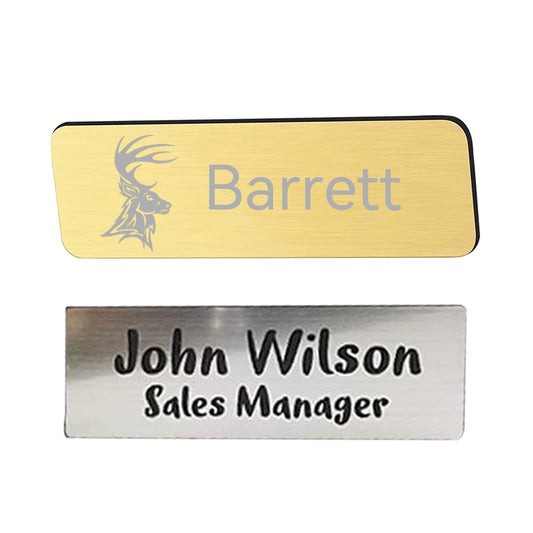 A set of 20 Packs 4 Colors Stainless Steel Blank Name Tags Badges Nameplate for Laser Engraving in various colors (silver, gold, blue, and white) arranged in four rows of five. Below the name tags, there's a metal name badge crafted with precision using laser technology that reads "John Wilson Sales Manager" with a magnetic fastener displaying the warning "CAUTION MAGNETIC." The product is by CrealityFalcon. 1600