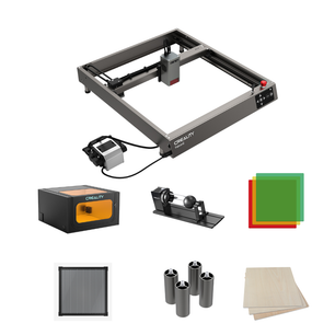 Photograph showcasing the Falcon2 40W Laser Engraver Bundle All-in-one Kit from CrealityFalcon, accompanied by its accessories. The kit includes a material storage box, rotary roller, color acrylic sheets, basswood plywood sheets, an aluminum honeycomb plate, metal cylinders, and wooden planks. Each accessory is displayed individually around the engraver.