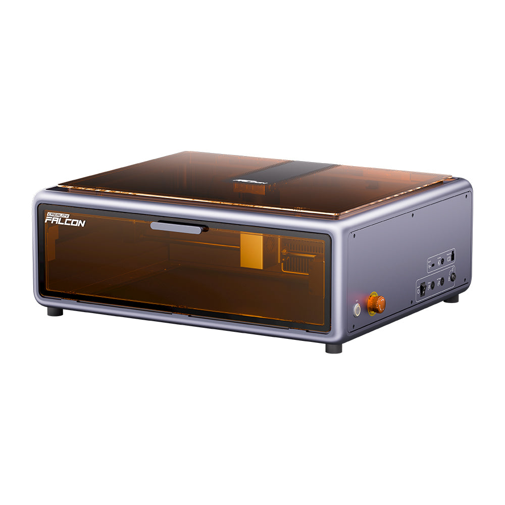 The Creality Falcon A1 10W Engraver and Cutter has a sleek rectangular design with a transparent orange cover. It features Auto Materials Recognition, control buttons on the right side, and visible internal mechanisms, offering a compact form that fits seamlessly into any space.