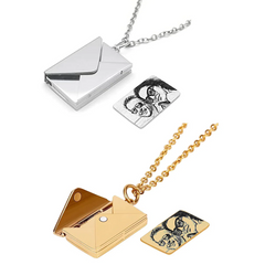 The Love Letter Envelope Necklaces - 2pcs by Creality Falcon include two stunning envelope-shaped lockets: one in shimmering silver and the other in radiant gold. These stainless steel necklaces feature a magnetic clasp for a secure hold, each containing a small card adorned with a black and white drawing of two people.