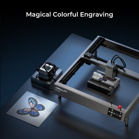 A CrealityFalcon Falcon2 22W Laser Engraver and Cutter is shown in operation. The machine is engraving a colorful butterfly design on a metal surface. The text "Magical Colorful Engraving" is displayed at the top.