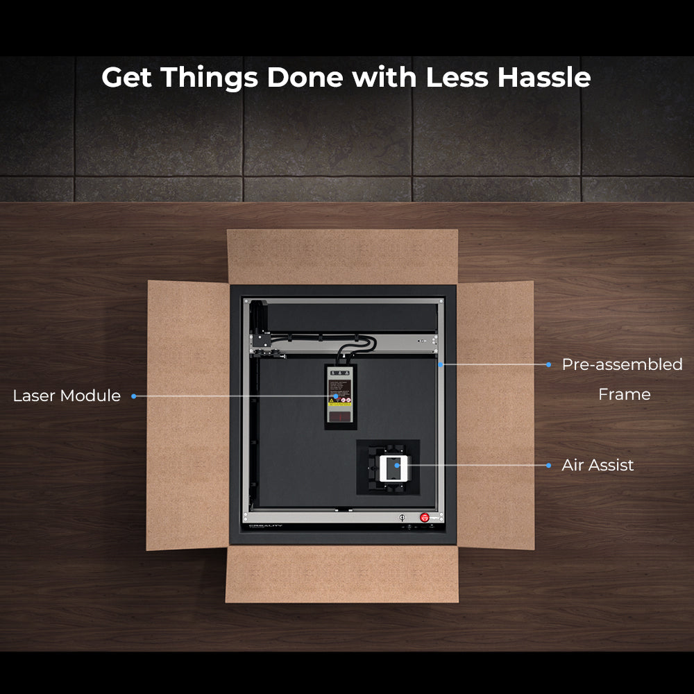 An open cardboard box rests on a wooden table. Inside, a partially assembled CrealityFalcon Falcon2 40W Laser Engraver and Cutter features labeled parts: "Laser Module," "Pre-assembled Frame," and "Air Assist." Above the box, text reads, "Get Things Done with Less Hassle.